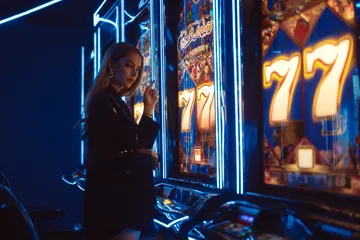 JILI7978 Slots — Thousands of thrilling machines await A woman smiling by bright slot machines showing lucky symbols, showcasing the exciting slot offerings at JILI7978.